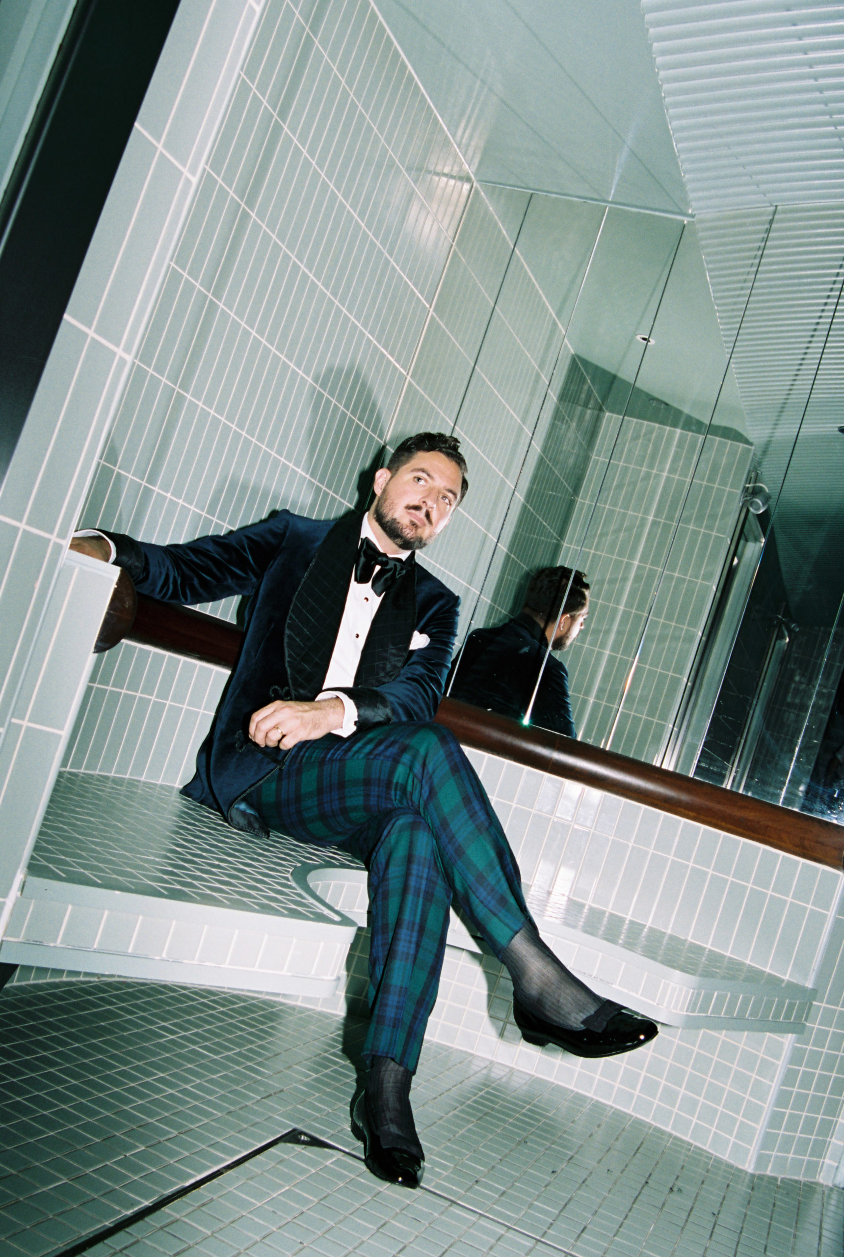 Gentleman wearing tartan trousers and bow tie for black tie outfit