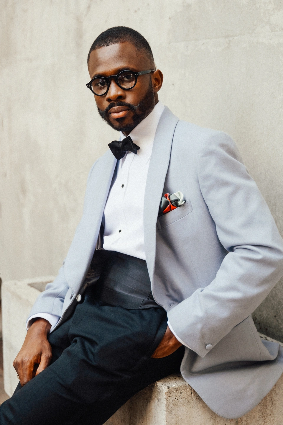 Gentleman wears a bow tie and cummerbund with his modern black tie outfit