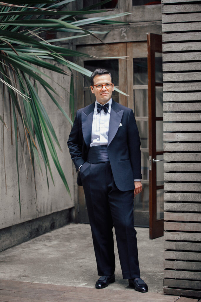 Man wearing a cummerbund with his black tie tailoring