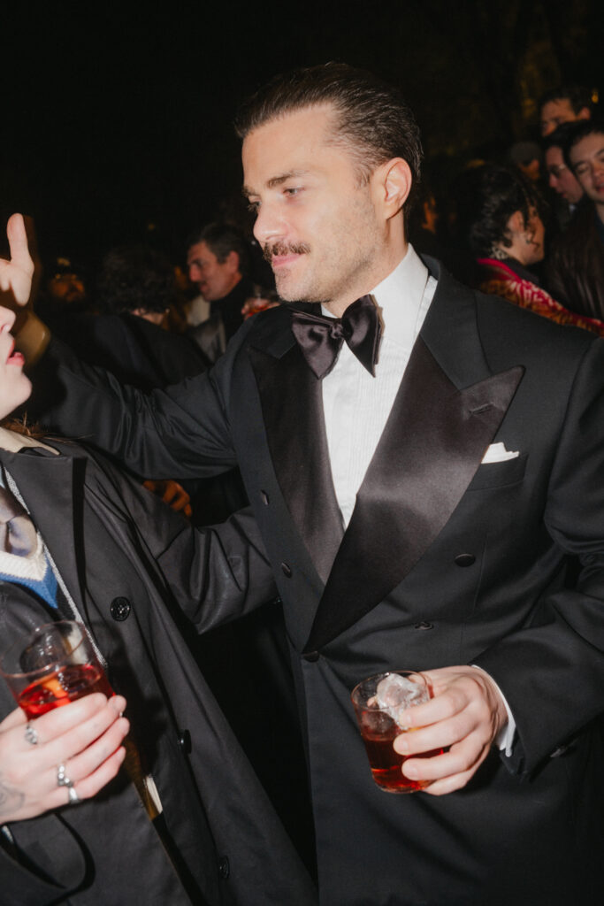 dapper man with moustache wearing black tie