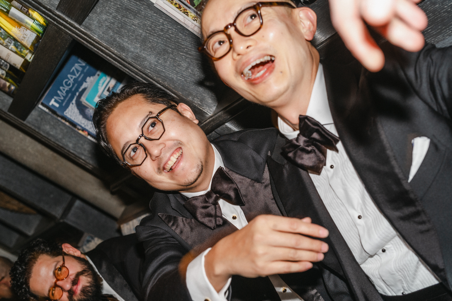 men smiling at a black tie dinner