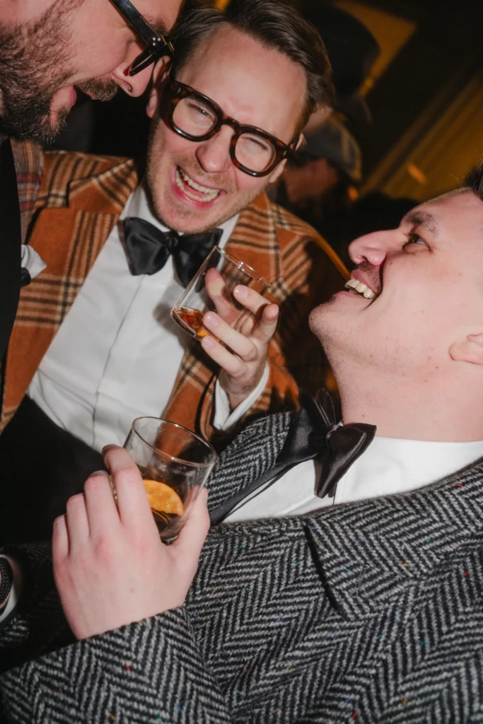 Men laughing wearing black tie