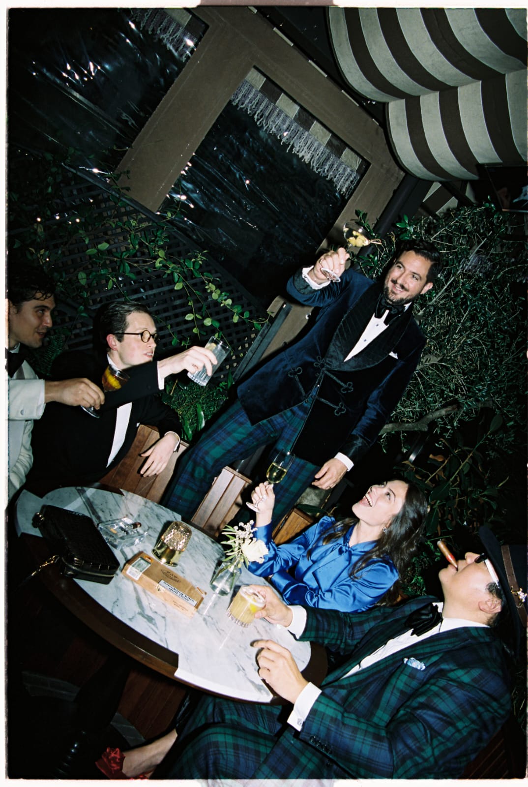 Main raises a glass to toast at a black tie dinner