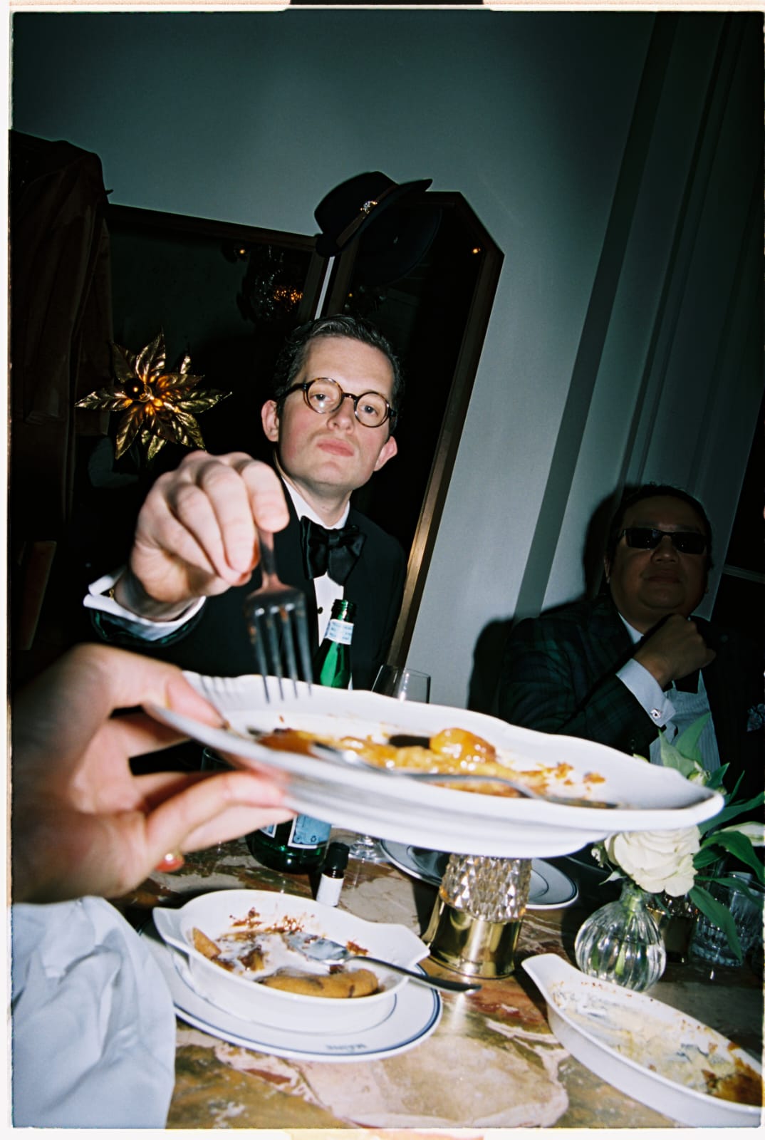 Man wearing bow tie and dinner suit having desert at a black tie dinner